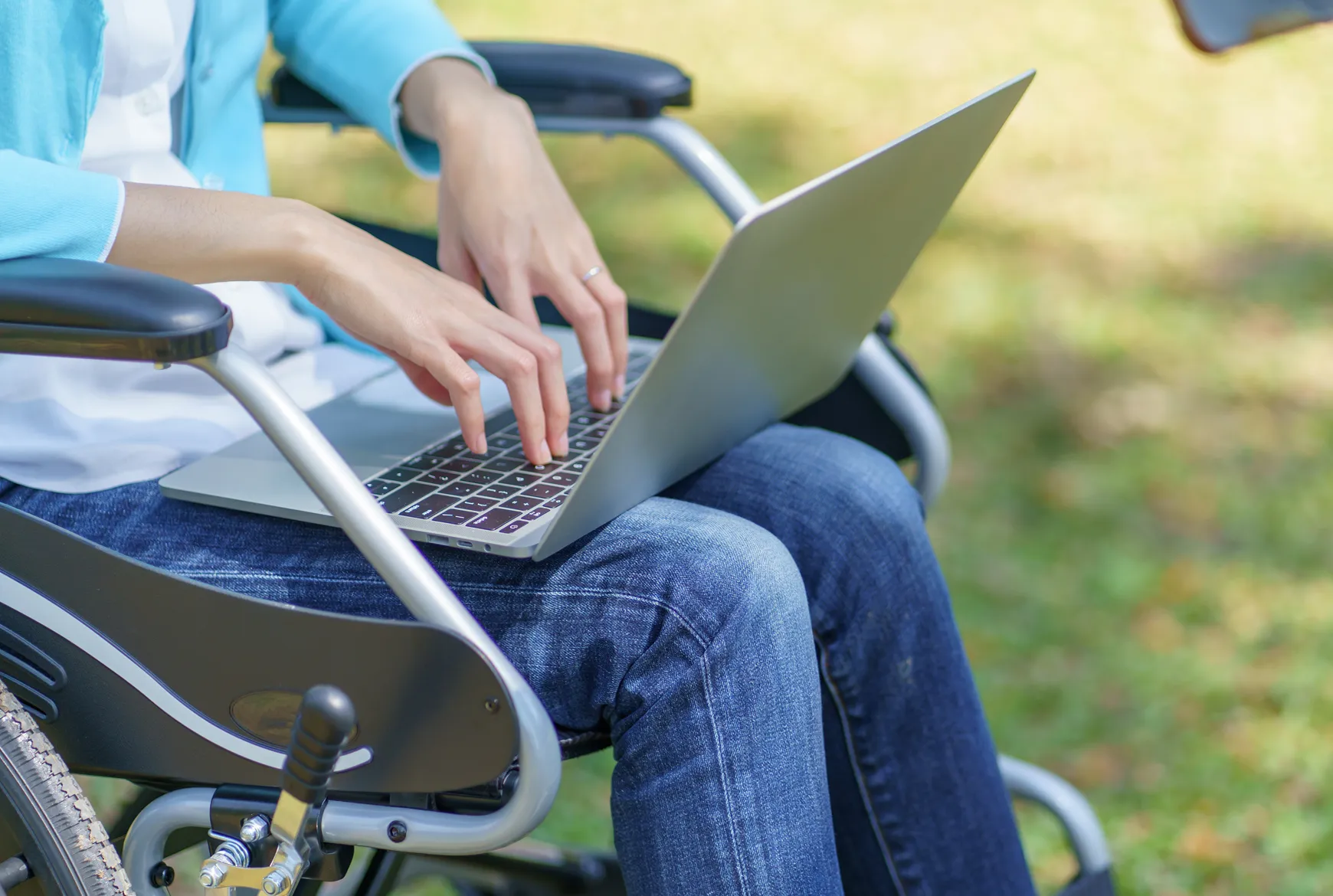 pflegedienst-beratung-unterstützen Person im Rollstuhl nutzt Laptop für digitale Pflegeberatung in Niedersachsen